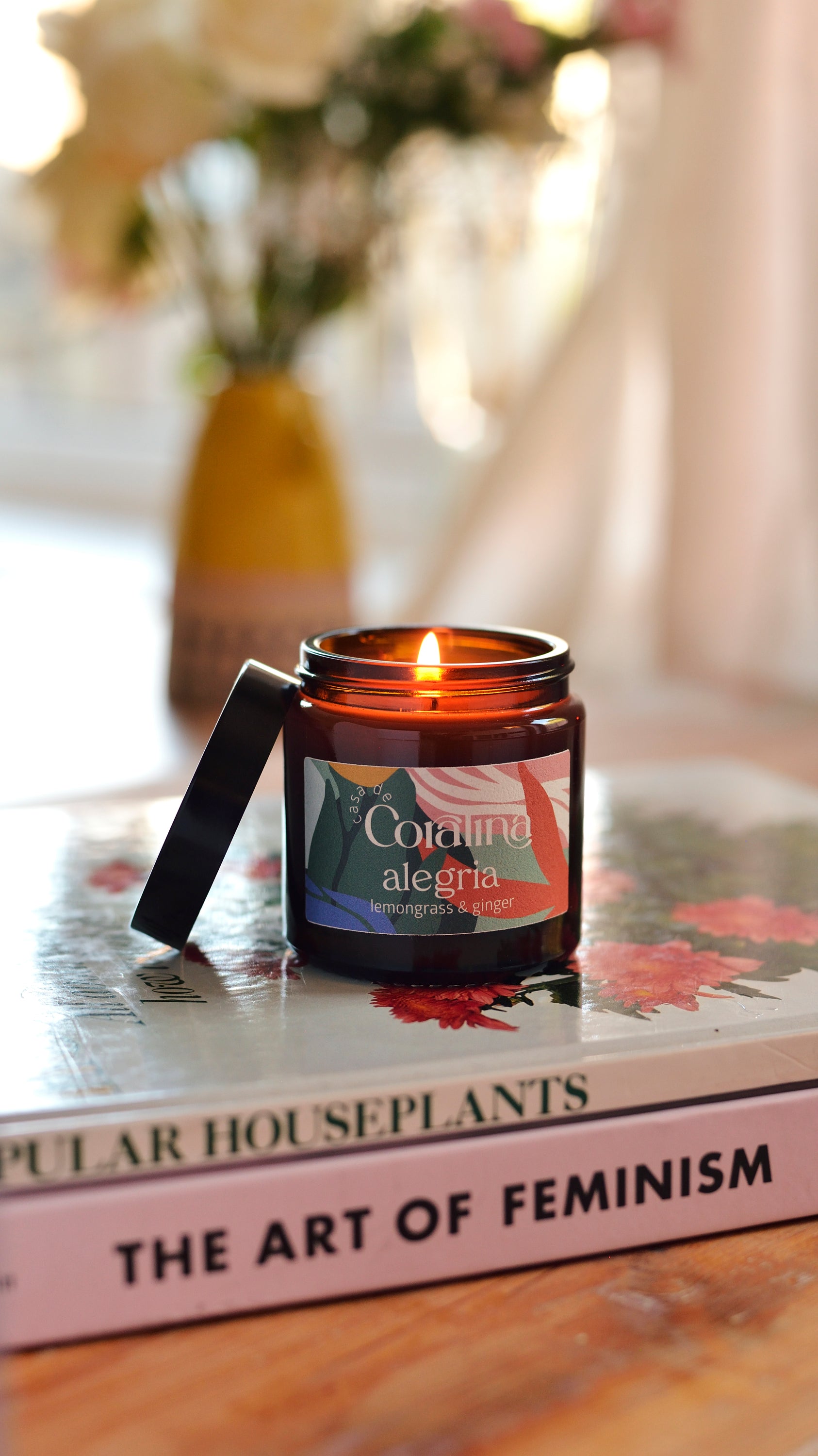 Candle in an amber jar on a book with a blurred background