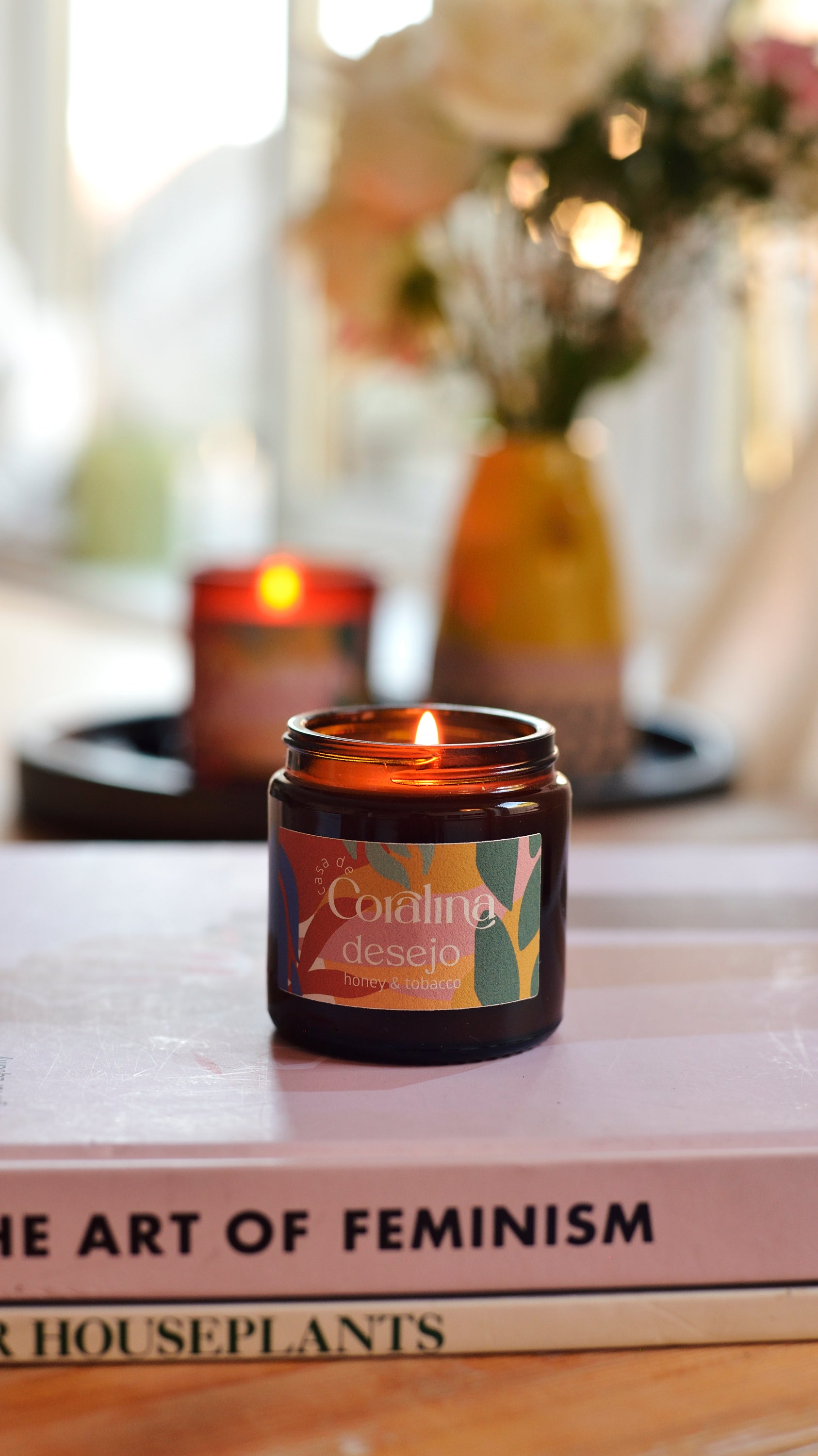 Candle in an amber jar on a book with a blurred background